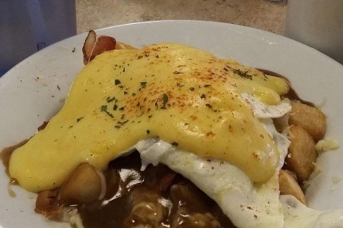 Classic eggs Benedict with Hollandaise over home fries