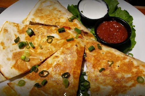Chicken quesadilla with sour cream and salsa